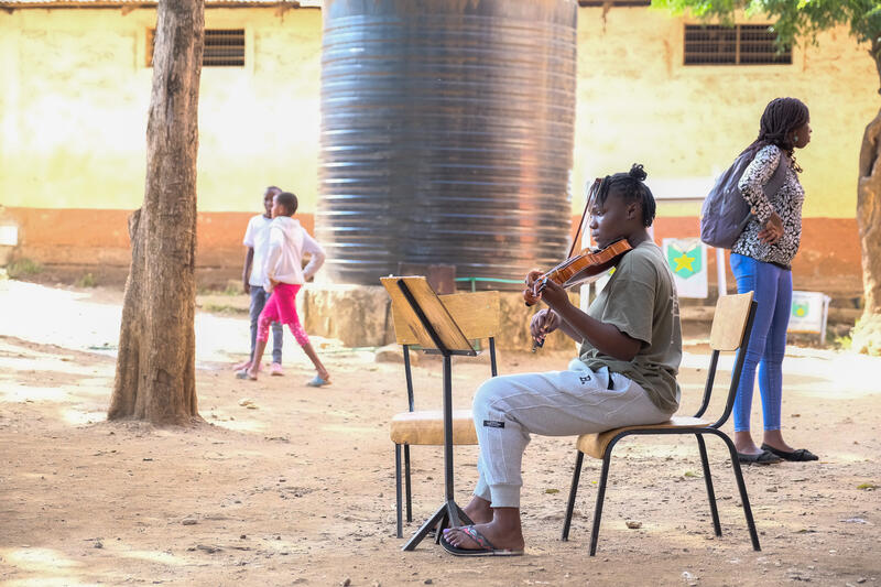 s:92:"Schülerin spielt Geige im Hof der katholischen St.-John-Schule im Slum Korogocho in Nairobi";